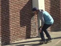A young man skateboarding on the sidewalk.  - Slow Motion Stock Footage