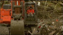 Rescue workers pause to observe minute's silence a week after deadly mudslide News Clip