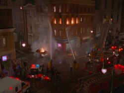 WS TU Firemen spraying water on corner of four story brick apartment building / Unspecified Stock Footage