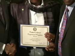 Captain Hosa Okumbo receives recognition from Congressman Bobby L. Rush (L) Stock Footage