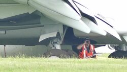 Air investigator looking for clues under airplane wing Stock Footage