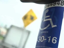Disability tag swings from rear view mirror in car Stock Footage