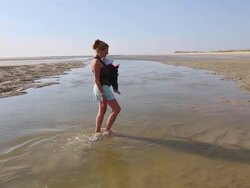 MS TS Shot of mother and baby walking on beach / St. Simons Island, Georgia, United States Stock Footage