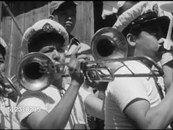 1951: FORMOSA, TAIWAN: ELECTIONS: Campaign truck pulling into town, people on truck w/ drums, flags, hand-made megaphone, VS Male shouting to crowd through megaphone, VS Unidentified woman using hand-held mic.   Elections, Democracy, propaganda. Instructional Video