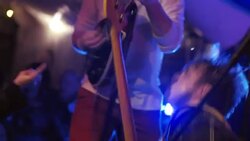 Insane rock guitarist plays on his knees on stage at music festival Stock Footage