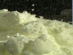 Sulphur mixed with hydrochloric acid. These two substances do not react. Compare this with the vigorous reaction of hydrochloric acid and iron, K002/4135 Stock Footage