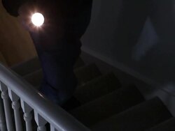 Intruder with flashlight on stairs. Stock Footage