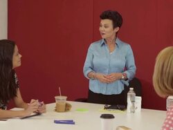 close up of Middle aged female executive presents idea in front of diverse colleagues Stock Footage