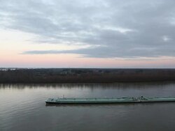 Barge sailing up the Mississippi river at dusk  aerial view Stock Footage