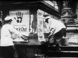 B/W 1910s women pasting up posters to buy Liberty Bonds / WW I / documentary Stock Footage