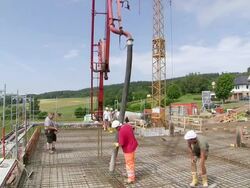 WS View of workmen casting concrete at house construction, building site / Hermeskeil, Rhineland Palatinate, Germany Stock Footage