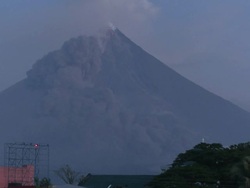 Ash cloud from pyroclastic flow drifts past side of large volcano: Mt Mayon, Philippines, December 2009 Stock Footage