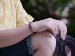 Slow motion pan of girl holding baby photo of herself with down syndrome. Stock Footage