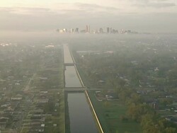 Wide Shot aerial push-in - Bridges span the canal that leads toward downtown New Orleans. / New Orleans, Louisiana, USA Stock Footage