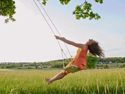 SLO MO Girl swinging on a tree swing Stock Footage