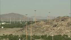 A Saudi Arabian town  spreads out below distant mountains. Stock Footage