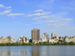 WS T/L View of Moving clouds over fresh green trees and Central Park East Residences at Reservoir / New York, United States  Stock Footage