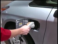 Drivers will pay more for cars and trucks but save money at the gas pump under tough government rules aimed at hastening a new generation of fuel-sipping gas-electric hybrids and total electric cars. Carmakers must achieve a 35.5 mpg average within six years. News Clip