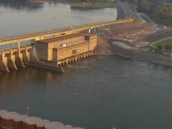 WS AERIAL View of powerlines to substation at powerhouse of Chickamauga Dam on Tennessee River with traffic crossing dam on Highway 153 / Chattanooga, Tennessee, United States  Stock Footage