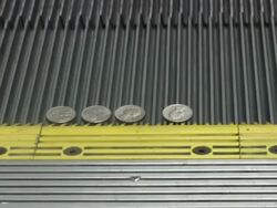 Cash money on escalator. Hundred dollar bills & coins. Currency. Stock Footage