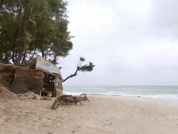 WS Desert island shelter on wild beach on overcast morning / Inhambane, Mozambique Stock Footage