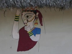 CU Painting of woman on thatched house / India Stock Footage