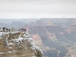 WS Tourists overlooking snow covered Grand Canyon at Mather Point / Grand Canyon National Park, Arizona, USA Stock Footage
