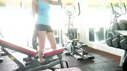 Woman Using  Machines In Gym Stock Footage