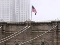 MS American flag blowing with wind on Brooklyn Bridge / New York, United States Stock Footage