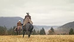 SLO MO Two cowboys riding horses in the mountains Stock Footage