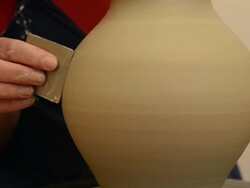 CU TU Shot of female potter finishing shaping and smoothing out pitcher on potterwheel at pottery / Landshut, Bavaria, Germany Stock Footage