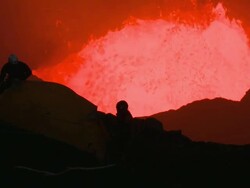 Lava erupts violently behind tent pitched on cliff, Marum Volcano, Ambrym Island, Vanuatu Stock Footage