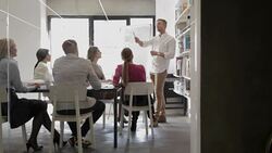 Businessman giving presentation, presenting businesswoman to the team Stock Footage