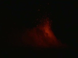 Lava fountains into the air behind a cloud of toxic volcanic fumes at night, Stromboli, Italy. March 2010 Stock Footage