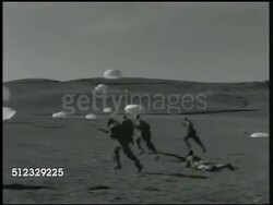 1942: U.S. PARAMARINES TRAINING: LANDING: WS Paratroopers landing w/ parachutes, marines w/ rifles advancing on ground. VS Soldiers laying flat on ground, moving out over hills, running across field, jumpers landing BG. Instructional Video