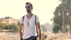 Man with longboard walking Stock Footage