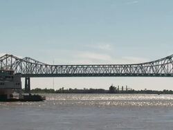 Wide Shot - Boat passes underneath bridge / New Orleans Louisiana  Stock Footage