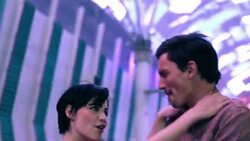 Young couple dance under the strobing lights of Fremont Street in downtown Las Vegas Stock Footage