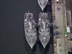 Aerial overhead view of Royal Navy ships docked at Faslane Naval Base / Scotland Stock Footage