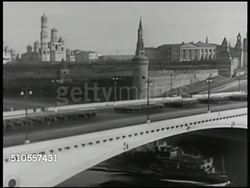 1950: MOSCOW: The Kremlin w/ soldiers marching on bridge over Moskva (Moscow) River FG. Communist Dictator Josef Stalin (1879-1953) standing in uniform coat, hat. Instructional Video