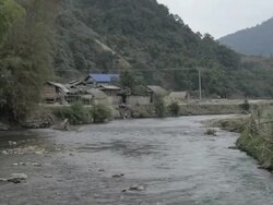 WS village on bank of river / Xam Neua, Laos Stock Footage