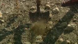 A shovel breaks ground near the ruins of Oudna Amphitheater in Tunisia. Stock Footage