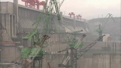 Cranes operate at the construction site of the Three Gorges Dam in China. Stock Footage