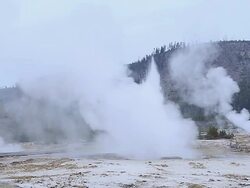 WS View of Erupting Geyser with steam at hot thermal springs (Biscuit Basin) near sunrise at River Firehole, UNESCO World Heritage Site. Biscuit Basin, Firehole River, Yellowstone National Park / Yellowstone, Wyoming, United States Stock Footage