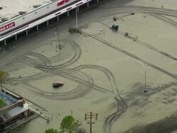 September 12, 2005 aerial tire tracks in mud-covered parking lot after flood / Chalmette, Louisiana Stock Footage