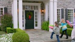 Family arrives at grandma's house for Christmas (dolly-shot) Stock Footage