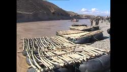 Afghans crossing river on homemade rafts News Clip