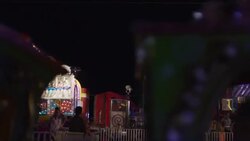 Wide panning slow motion shot of crowds at amusement park rides / Pleasant Grove, Utah, United States Stock Footage