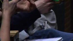 Anonymous people looking at smartphones during conference News Clip