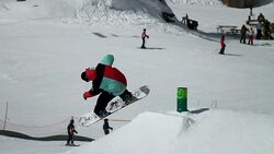 Snowboarder jumps in a snow park Stock Footage